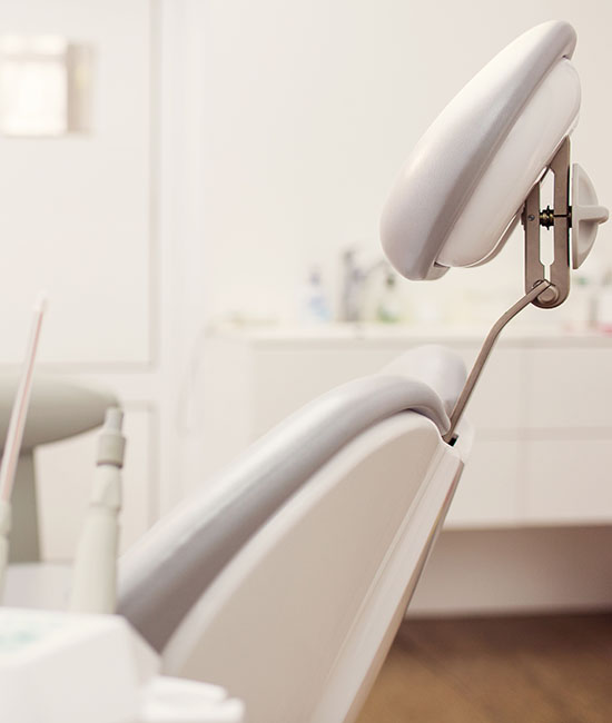 The image shows a dental chair with an adjustable headrest positioned upwards, suggesting a focus on oral care and patient comfort within a dental office setting.