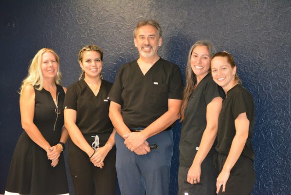 Dr. Villalobos with dental office staff